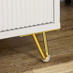 Close-up of white chest base with gold legs and foot glides