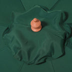 Close-up of green umbrella canopy top with orange finial knob and gathered fabric