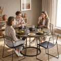 Round dining table with rustic brown woodgrain top and black conical pedestal base