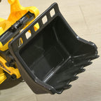 Close-up of yellow ride-on bulldozer’s black front bucket attachment