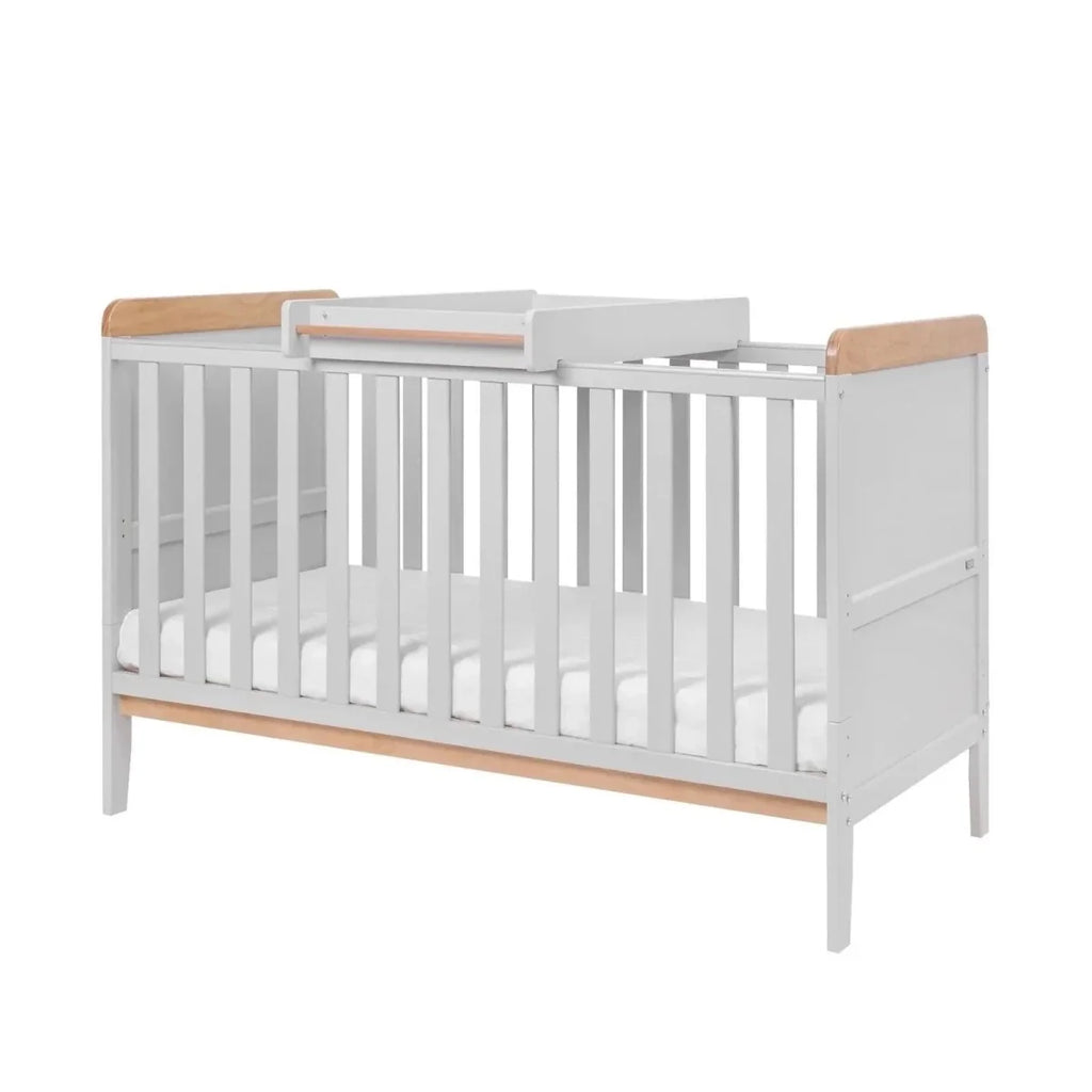 Baby cot bed with cot top changer, dove grey frame with honey oak top rails, front view