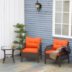 Two outdoor rattan bistro armchairs with orange cushions