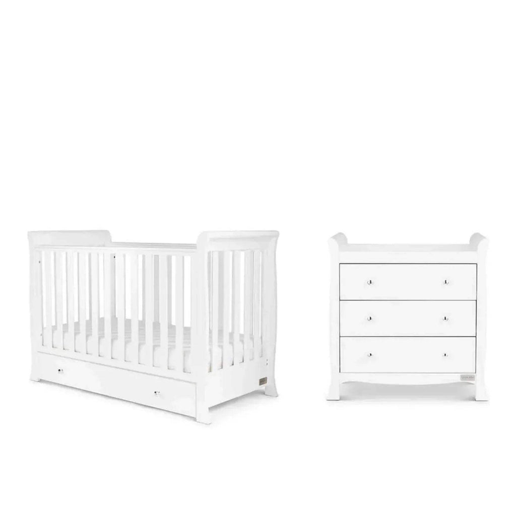 White mini crib and matching drawer dresser with slatted rails