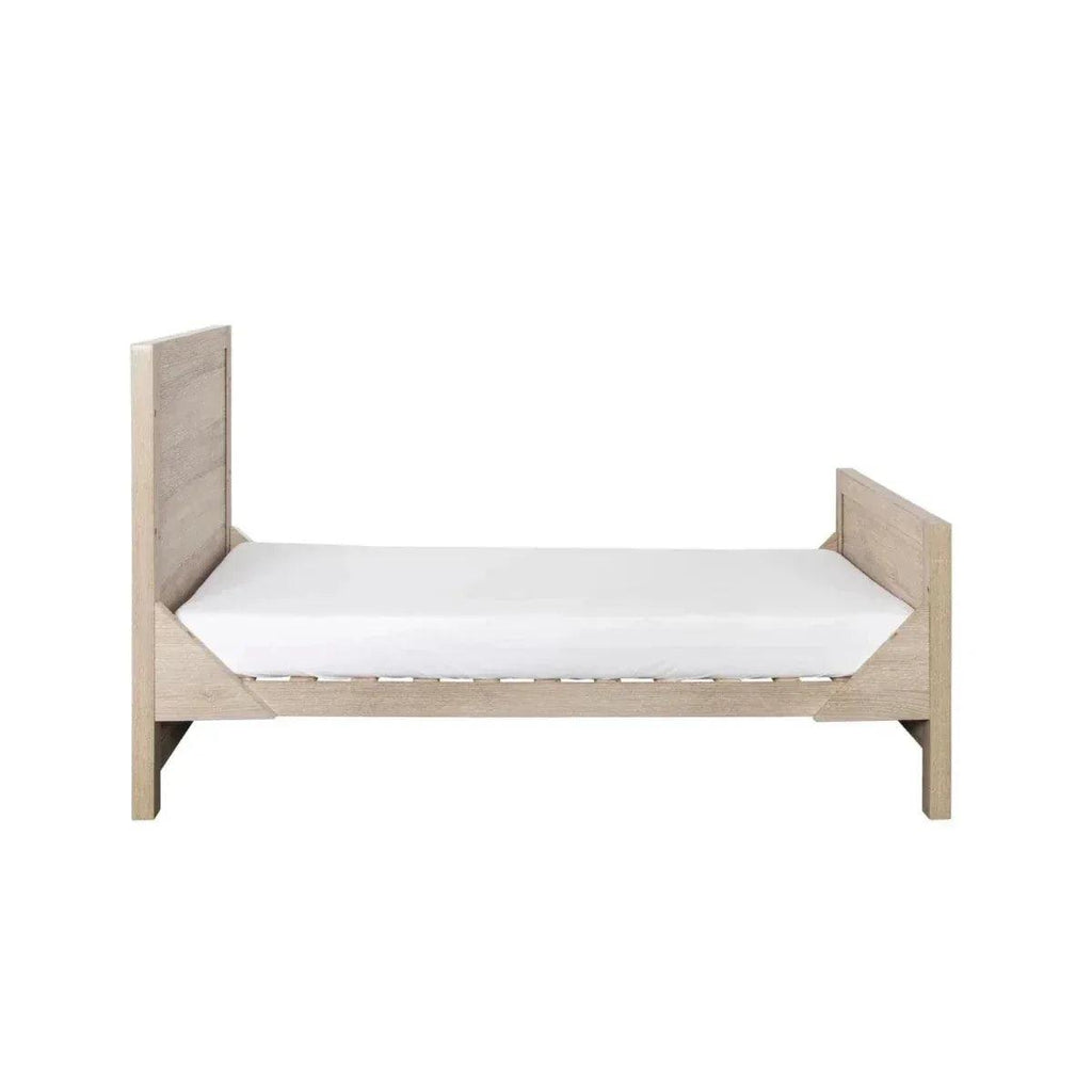 Low oak bed frame with white mattress and side guard panels