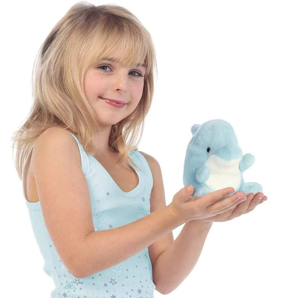 Light blue plush dolphin toy held by a child, soft plush with white belly patch