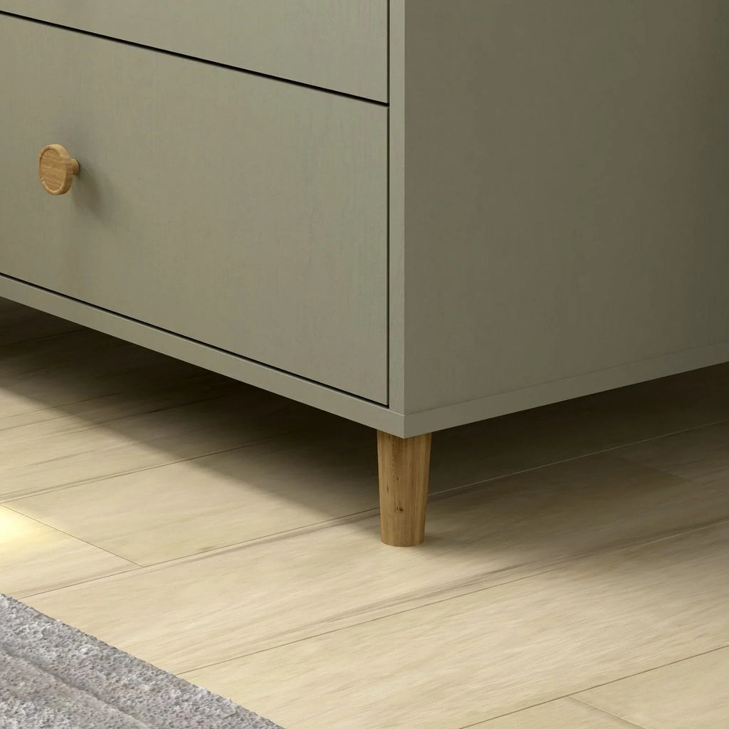 Grey changing dresser base with wooden legs and drawer fronts, brass knob detail close-up