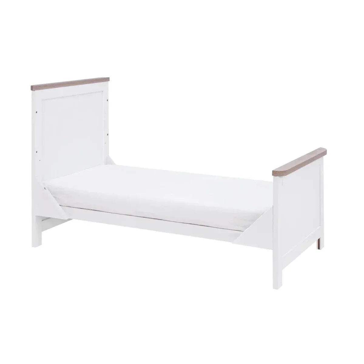 White sofa-style bed with oak armrests and a low slatted side