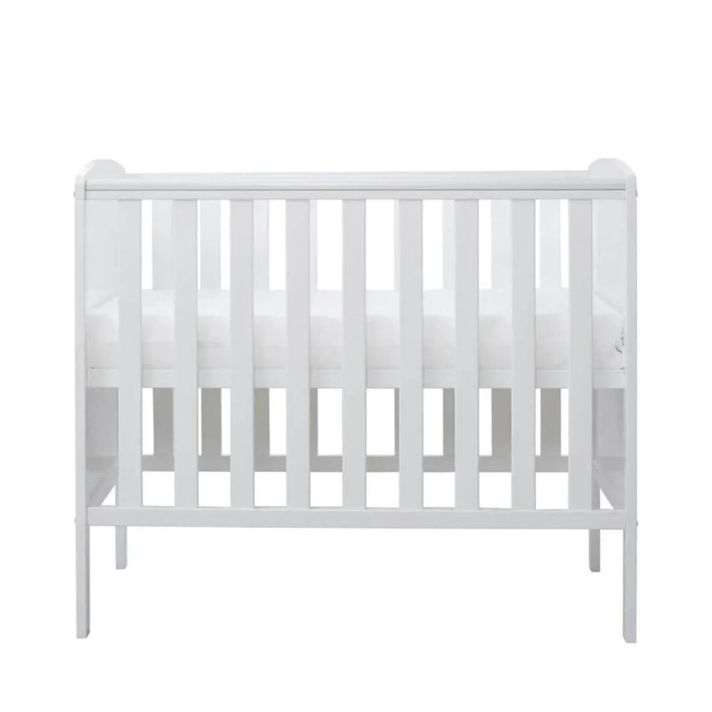 White cot with evenly spaced vertical slats and four legs