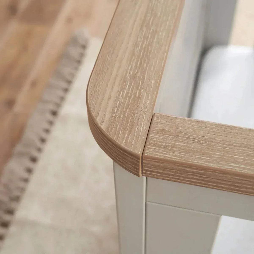 Oak and white cot bed corner detail with curved oak rail and white panels