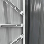 Grey metal shed door latch and internal locking bar on the double-door edge