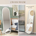 White arched mirror shown freestanding and leaning against a wall