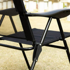 Black folding recliner patio chair close-up of armrest and steel frame with locking points