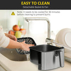 Black and grey air fryer with detachable basket being removed for cleaning
