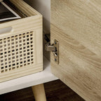 TV stand storage door hinge and handle hardware on natural wood-effect panel.