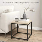 Small nest side table with oak-look top and black frame beside a sofa