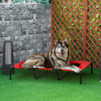 Red elevated pet cot with breathable black mesh panels, shown with a resting dog