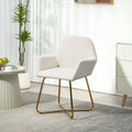 Cream upholstered accent chair front view with channel tufted back, curved arms, gold metal base