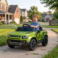 Green kids ride-on car with smiling child driving outdoors on a driveway