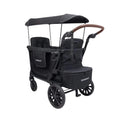 Black quad stroller wagon with canopy, padded seats, harness straps, and large wheels