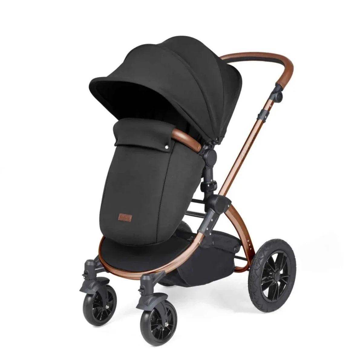 Black stroller seat with padded sides, bronze frame, and tan details on the chair