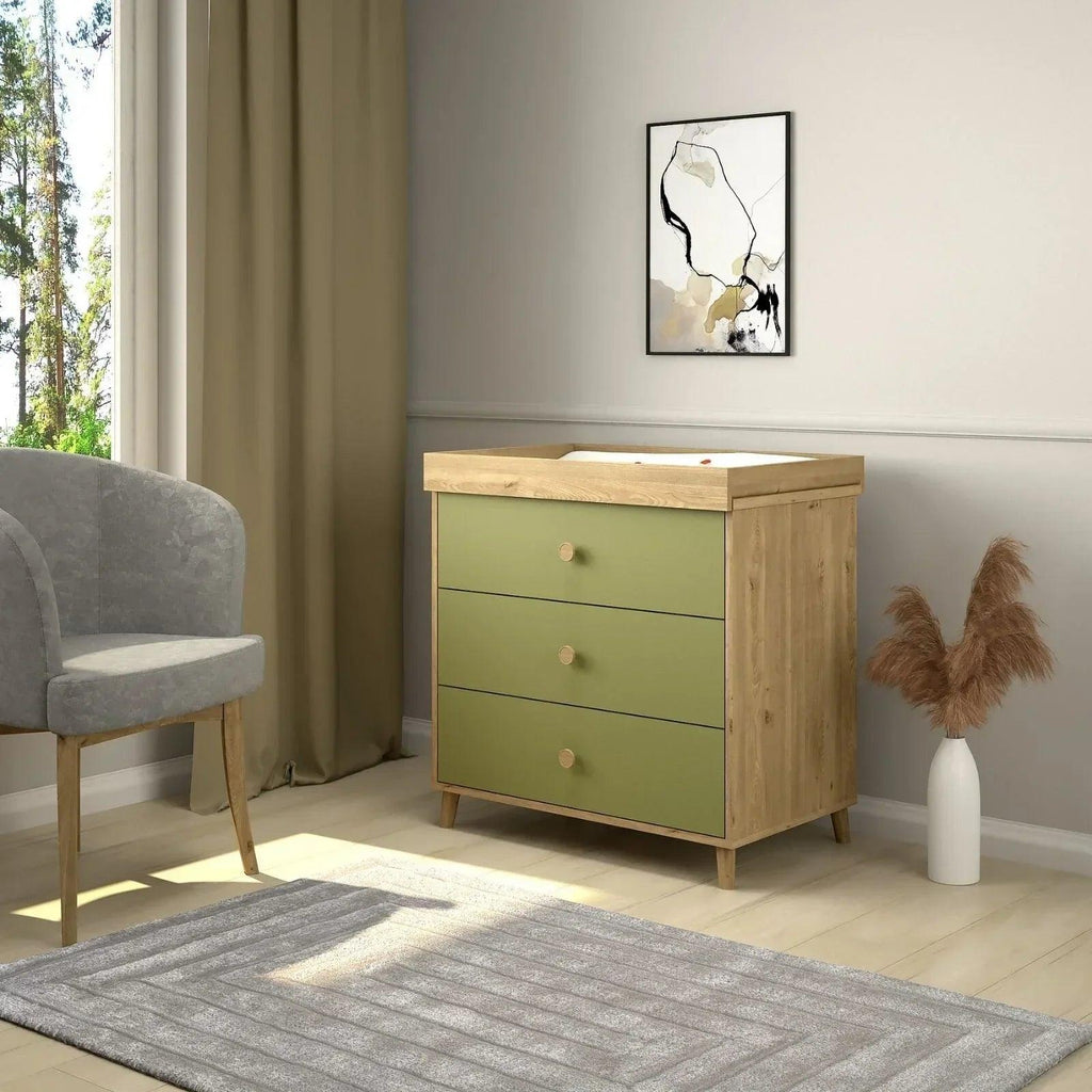 Kids changing dresser in pistachio green with three drawers and light wood sides