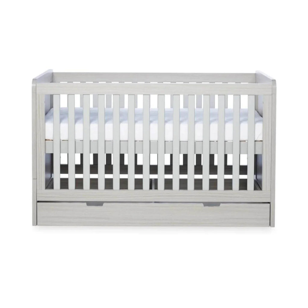 Ash grey cot bed interior view with white mattress and vertical slat rails