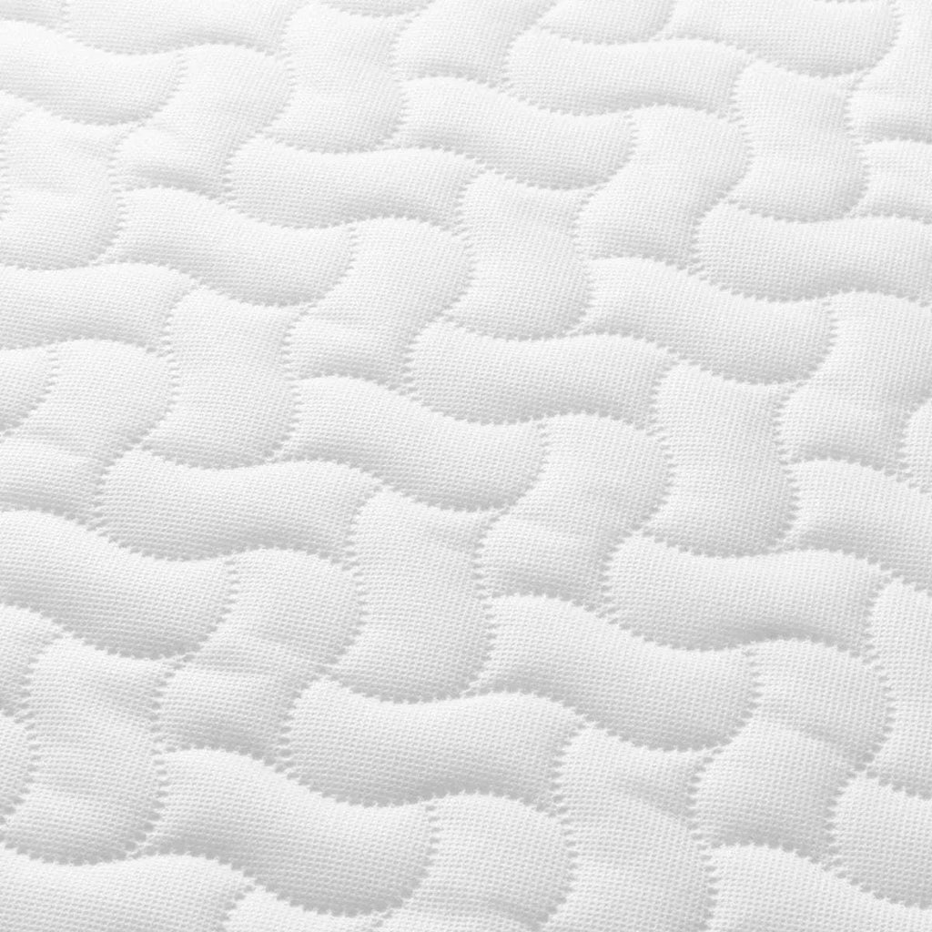 Tutti Bambini cot bed mattress, white quilted fabric texture close-up