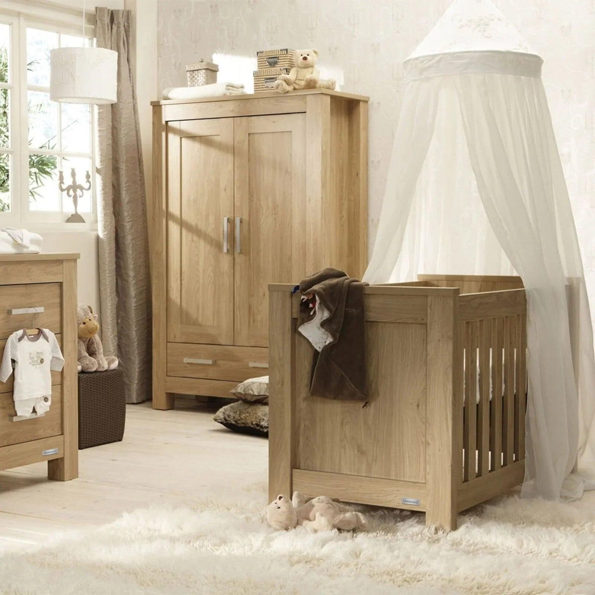 Oak cot bed with open slats and padded mattress in a nursery