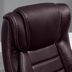 Brown PU office chair backrest with curved padding and contrast stitched seams