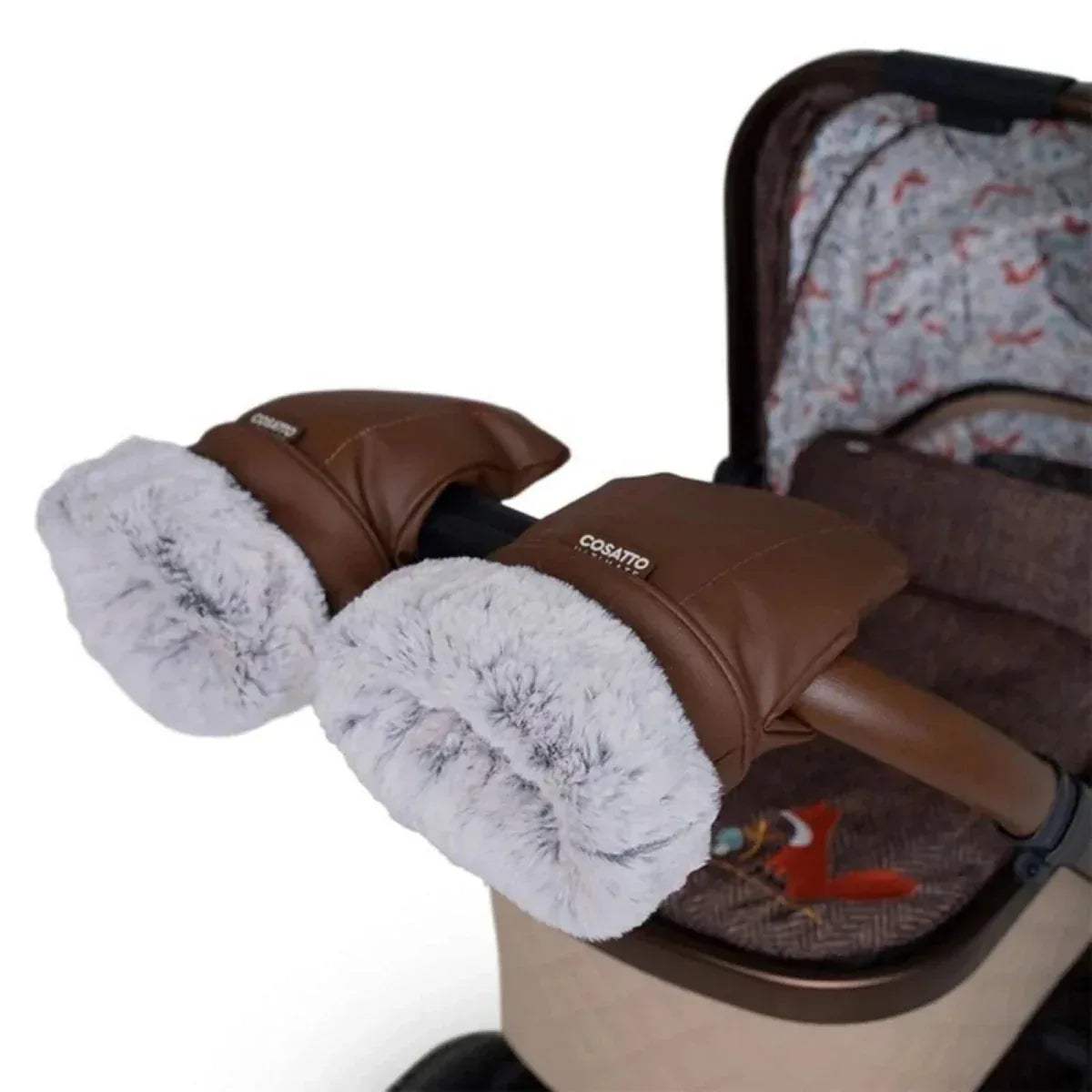 Tan heated mitts resting on a stroller handle with grey faux-fur cuffs