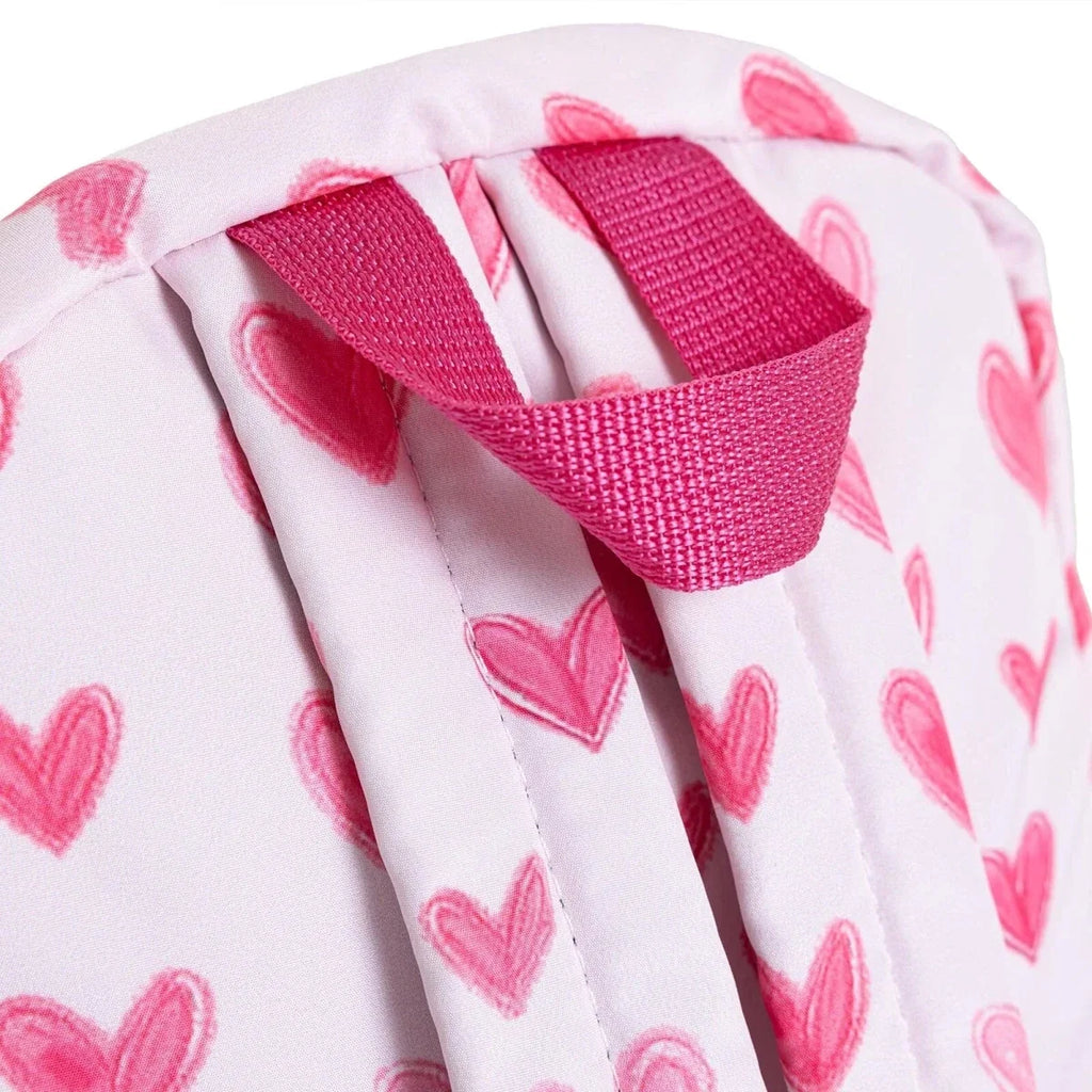 Pink heart-print backpack with fold-over top straps and textured pink webbing loops