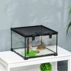 Black glass terrarium tank with green water basin and thermometer strip near rocks
