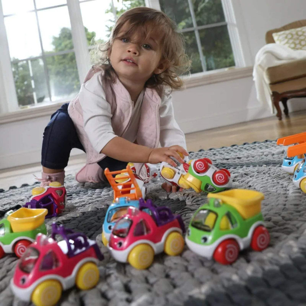 Assorted colorful mini toy cars with smiling faces and large rounded wheels