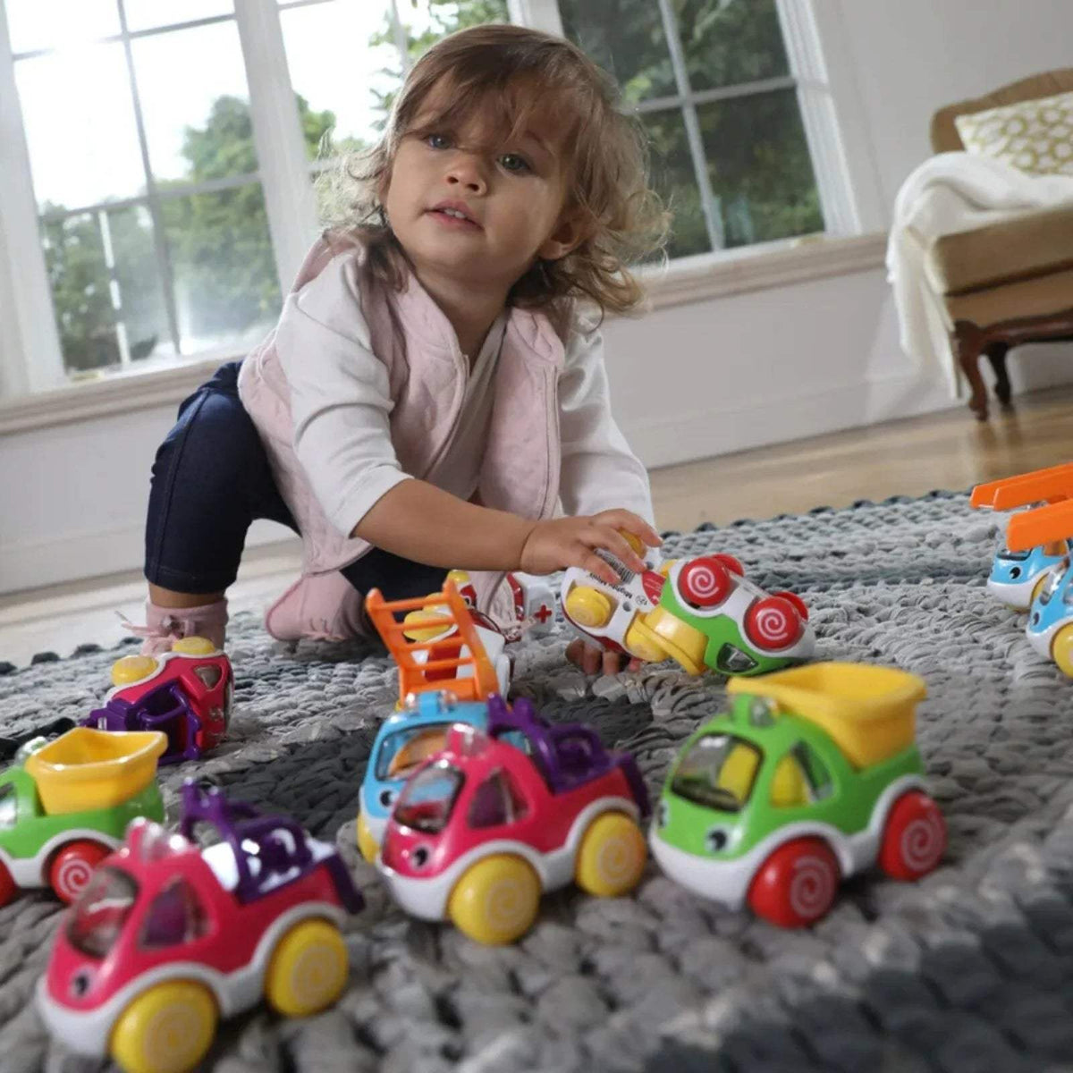 Assorted colorful mini toy cars with smiling faces and large rounded wheels
