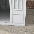Close-up of grey plastic dog house front base and doorway frame