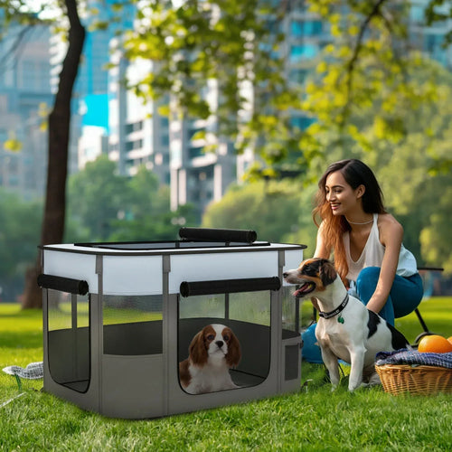 Grey portable dog playpen with mesh walls and two doorway openings, set outdoors on grass