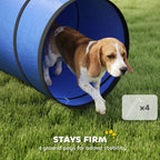 Blue fabric dog tunnel with dark rim edges, with a dog entering the circular end