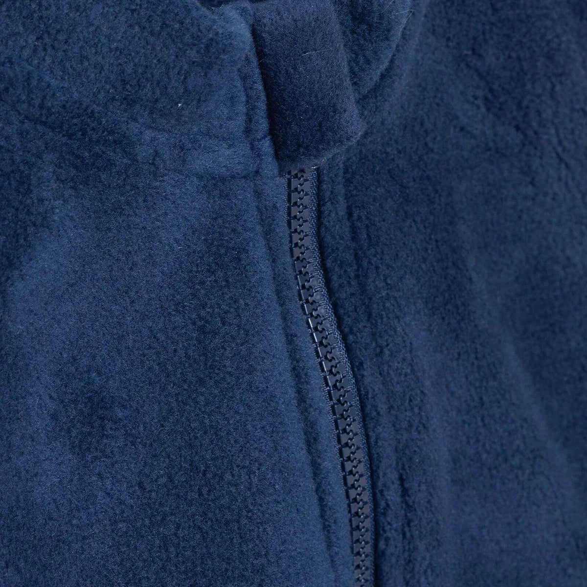 Navy blue fleece gilet close-up of front zip and funnel neck