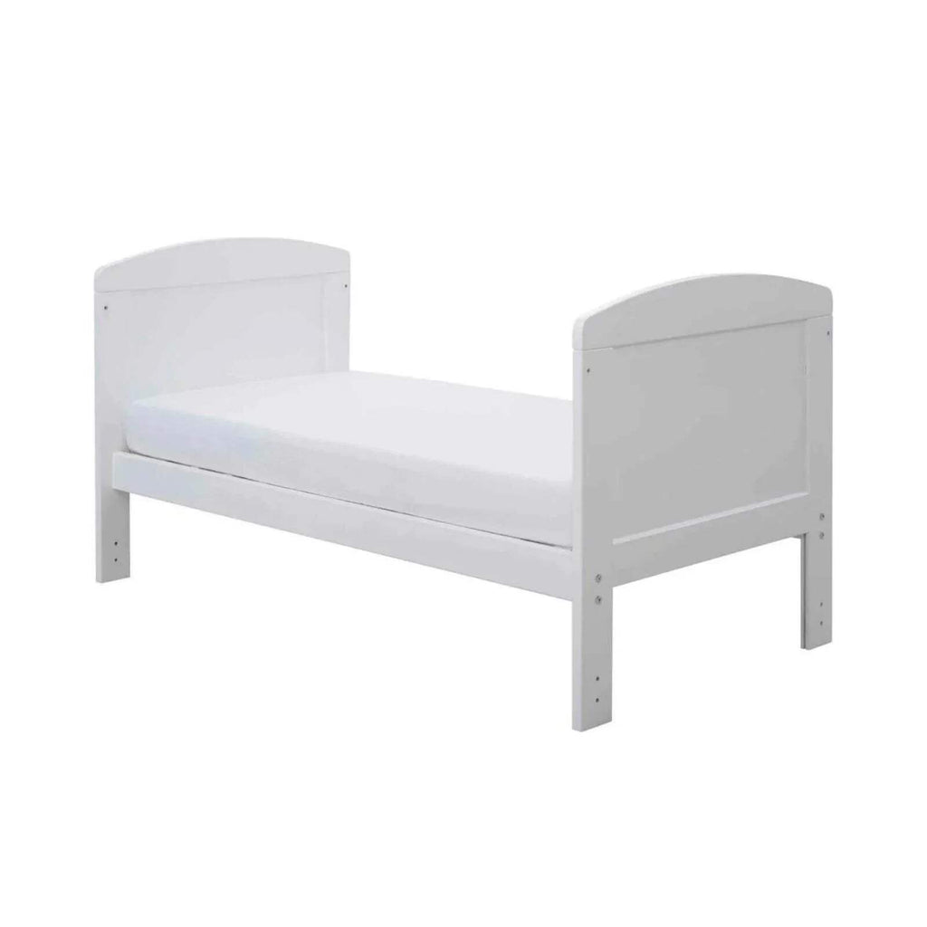 White mini cot bed with rounded end caps and slatted base, without mattress