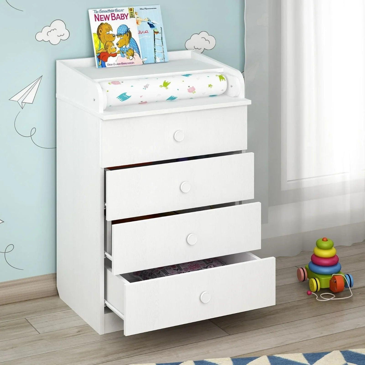 White changing dresser with cushioned changing pad and 3 front drawers