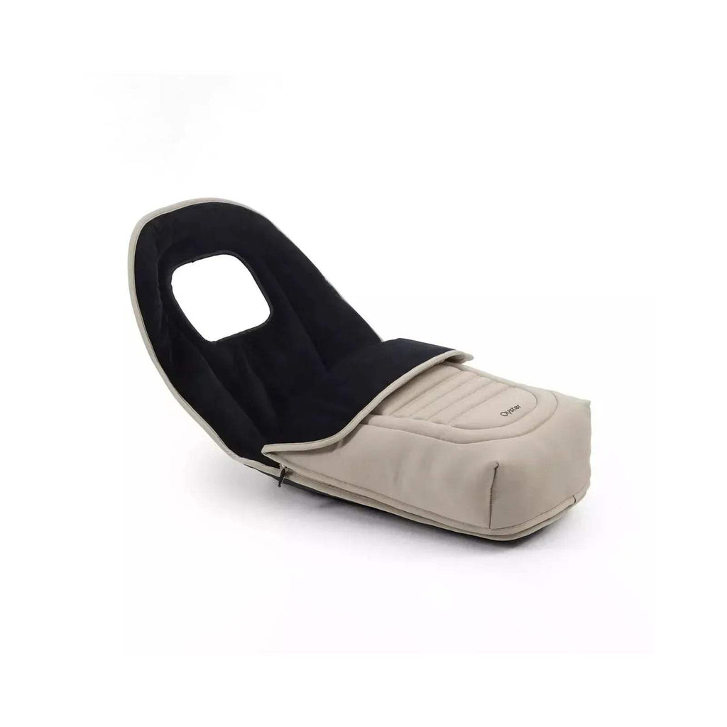 Buttermilk stroller seat with black interior lining, padded footrest, and curved handle frame