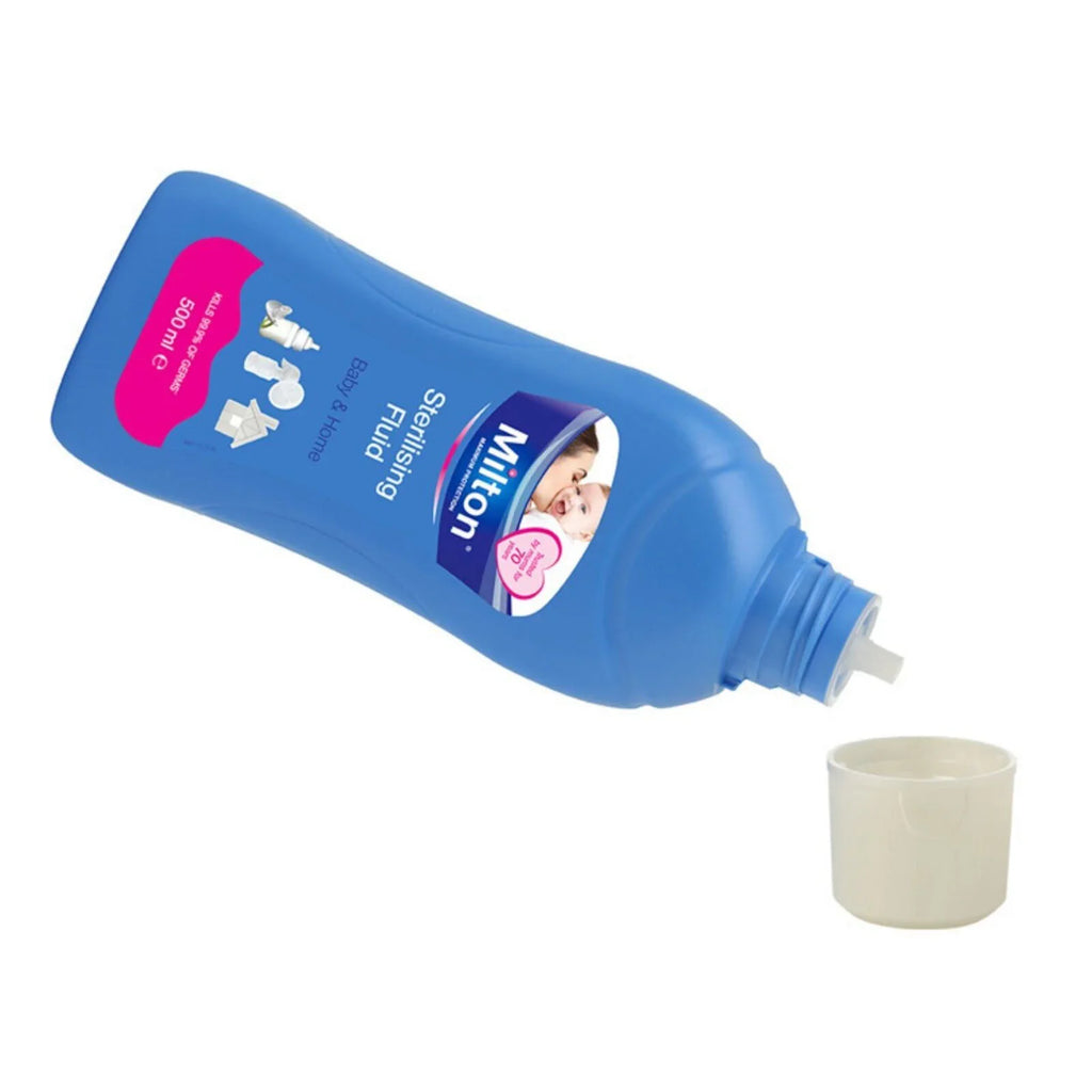 Milton sterilising fluid 500ml bottle tilted, nozzle pouring into cup