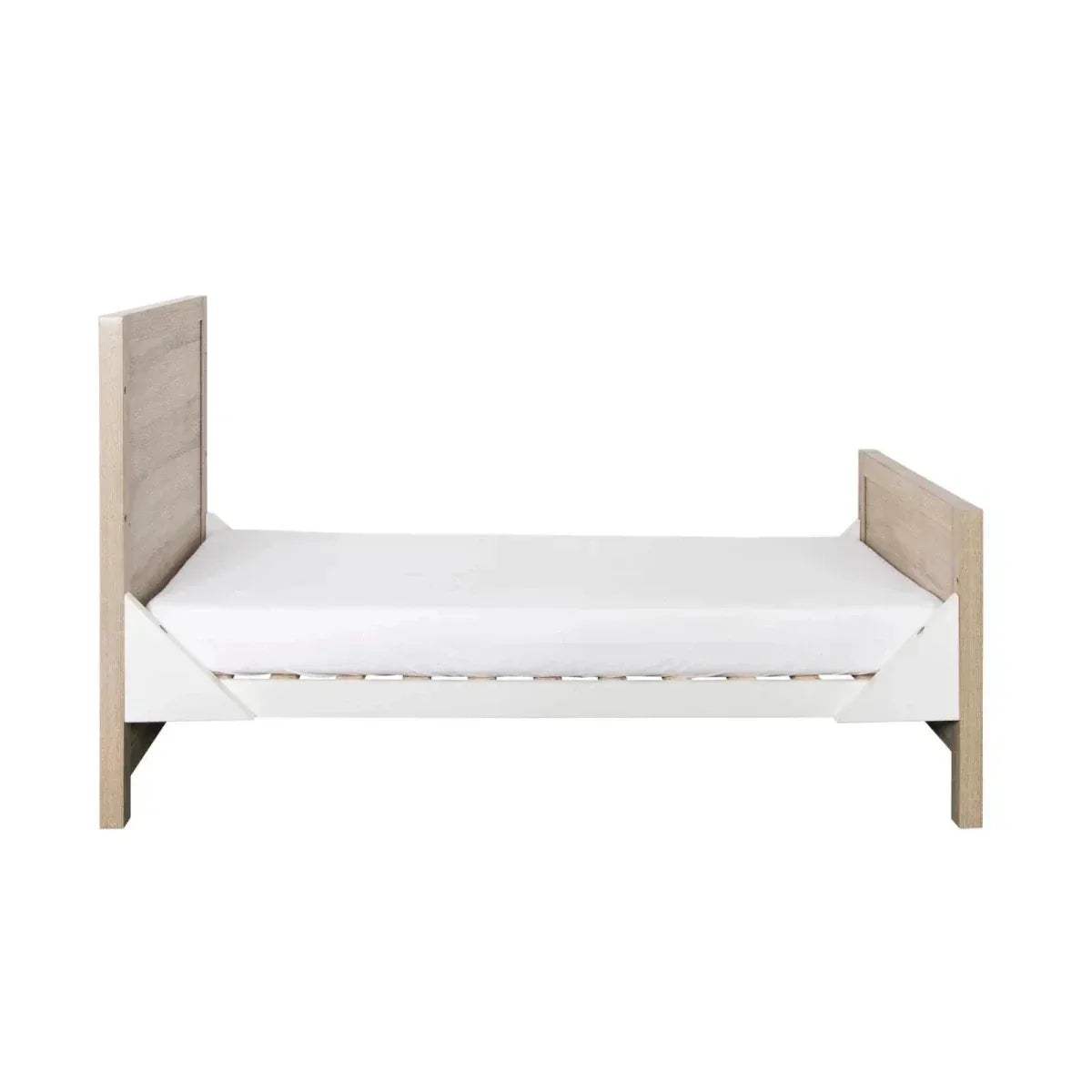 Oak and white wooden cot bed with side rails and padded mattress