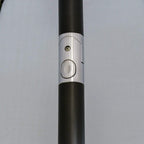 Black parasol pole joint with silver ring detail, close-up