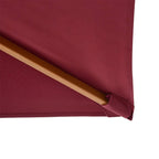 Wine red parasol canopy corner with wooden support bar and fabric hem seam.