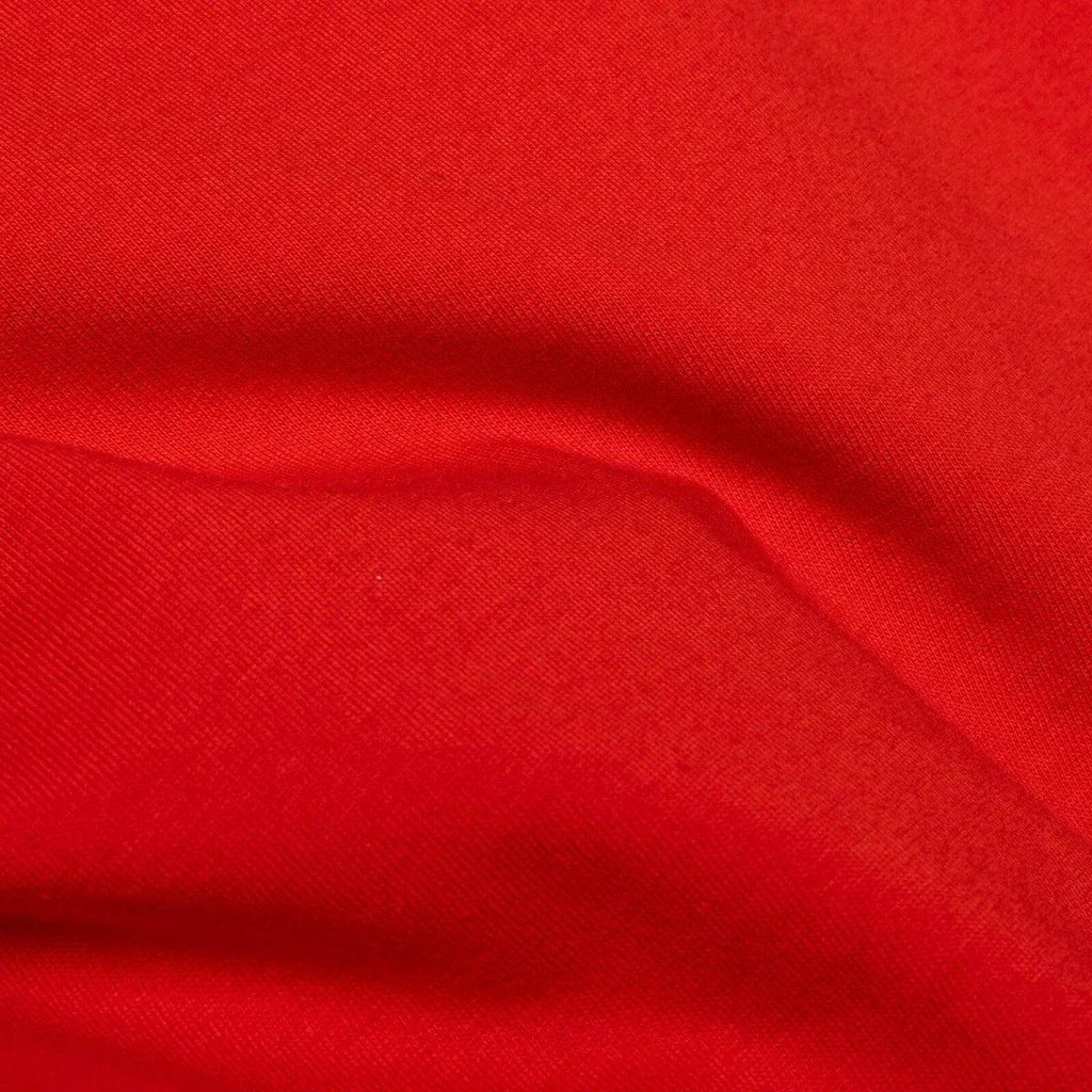 Red knit baby blouse fabric close-up