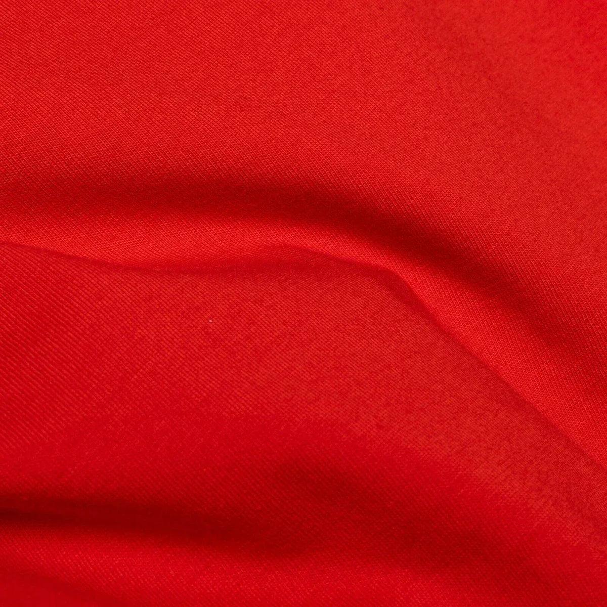 Red knit baby blouse fabric close-up
