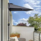 Grey half umbrella canopy mounted on a tall pole for outdoor balcony sun protection
