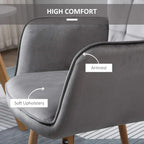 Grey upholstered wingback armchair with soft padding, curved armrest, and tufted back