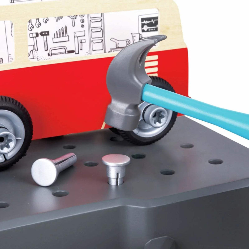 Toy car repair scene with blue wrench and gray workbench peg holes
